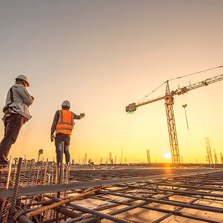 Two workers standing on top of a rebar structure